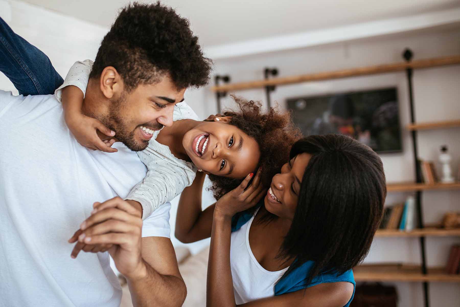Happy african american family having fun at home.